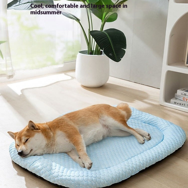 Large blue breathable cooling mat for dogs resting on a wooden floor.